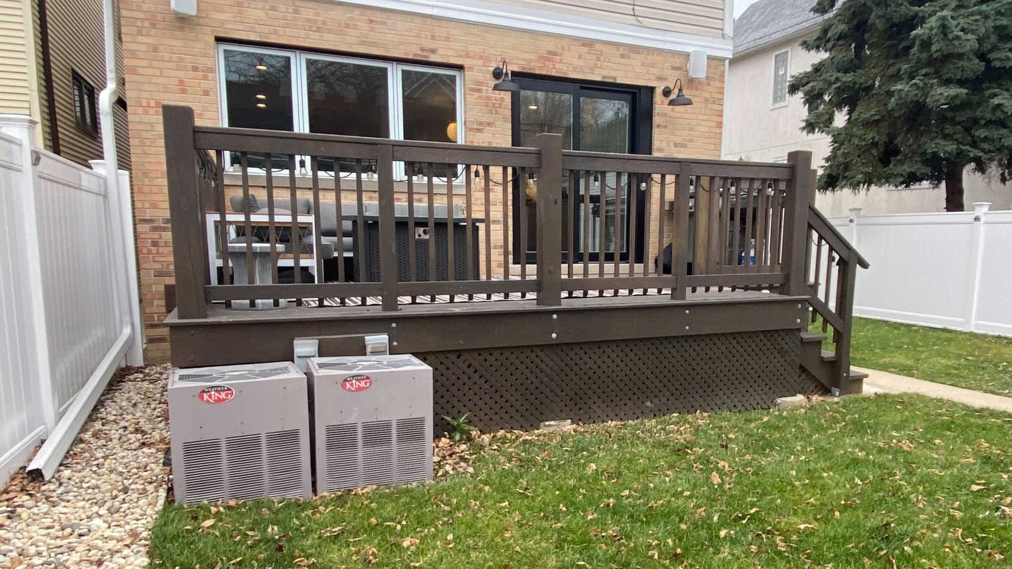 Before photo of of backyard deck with awkwardly placed steps to the side