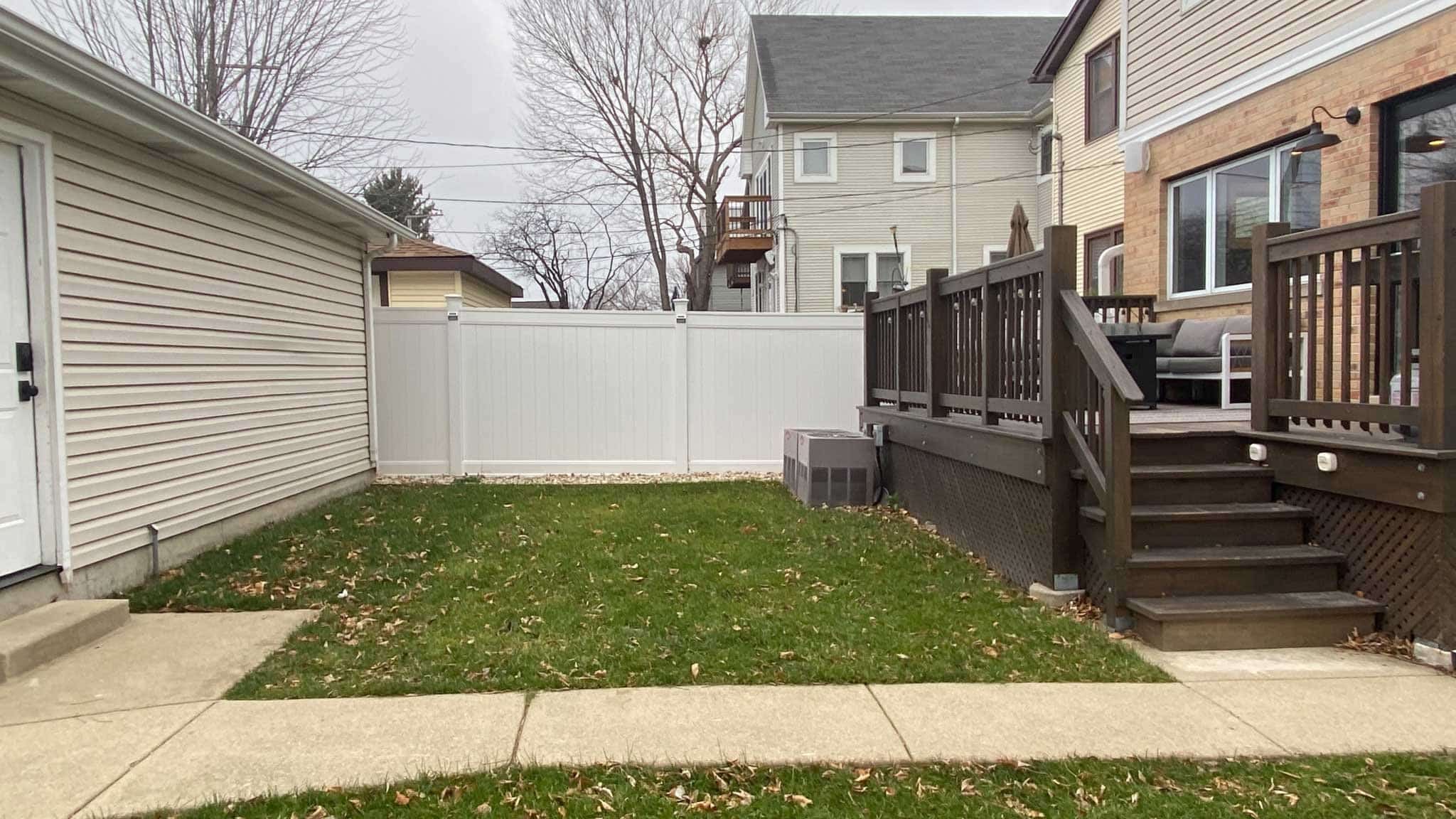 Before photo of yard with lawn and awkward concrete walkway