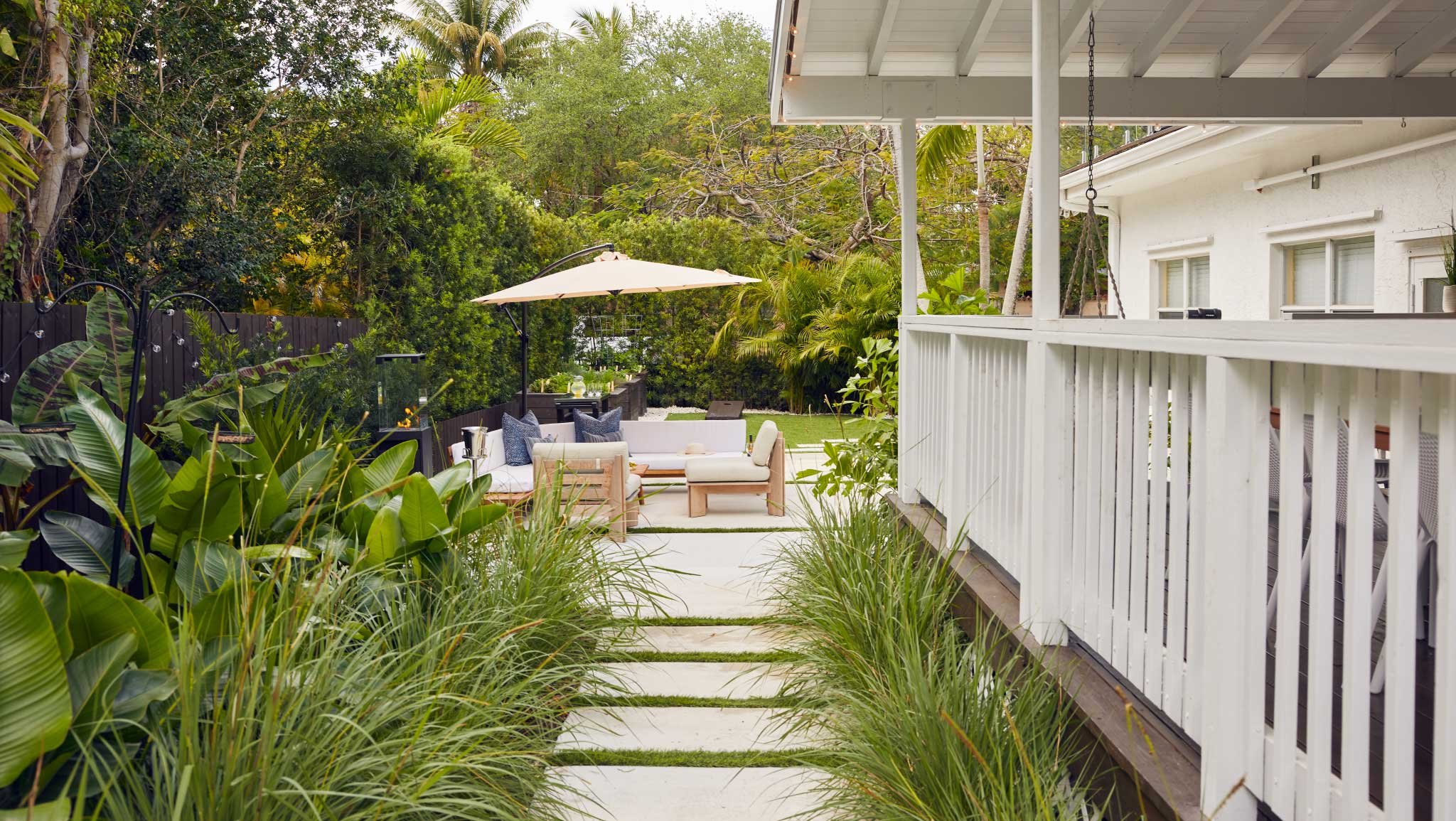 Lush tropical style side yard with concrete stepper path